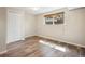 Cozy bedroom with laminate wood flooring, a window for natural light, and a closet for storage at 6490 S Pontiac Ct, Centennial, CO 80111