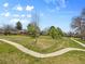 Landscaped yard featuring a sidewalk and mature trees enhancing this home's curb appeal at 6490 S Pontiac Ct, Centennial, CO 80111