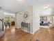 Hallway showcasing hardwood floors, neutral walls, and access to the living and dining areas at 6490 S Pontiac Ct, Centennial, CO 80111