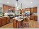 Lovely kitchen featuring an island with granite countertops, wood cabinets, and stainless steel appliances at 6490 S Pontiac Ct, Centennial, CO 80111