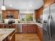 The kitchen offers stainless steel appliances, granite countertops, wood cabinets, and great natural light at 6490 S Pontiac Ct, Centennial, CO 80111
