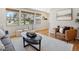 Bright living area with large windows, hardwood floors, and a comfortable seating arrangement at 6490 S Pontiac Ct, Centennial, CO 80111