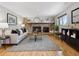 Spacious living room includes brick fireplace, hardwood floors, and a cozy seating area at 6490 S Pontiac Ct, Centennial, CO 80111