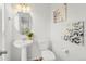 Clean and bright half bathroom with pedestal sink and toilet at 1143 Autumn Star Pt, Monument, CO 80132