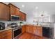 Modern kitchen with stainless steel appliances and wood cabinets at 1143 Autumn Star Pt, Monument, CO 80132