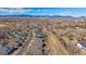 Wide aerial shot capturing the neighborhood, surrounding landscape, and mountain views at 12957 W 78Th Cir, Arvada, CO 80005