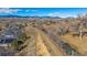 Wide overhead shot showing neighborhood bordering open space and waterway, with mountain backdrop at 12957 W 78Th Cir, Arvada, CO 80005