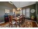 Formal dining room featuring a large wooden table, area rug, and stylish lighting fixture at 12957 W 78Th Cir, Arvada, CO 80005