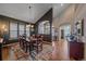 Dining area featuring a large wooden table, area rug, and stylish lighting fixture at 12957 W 78Th Cir, Arvada, CO 80005