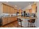 Bright kitchen with granite countertops, a large island, and stainless steel appliances at 12957 W 78Th Cir, Arvada, CO 80005