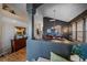 Elegant dining room with dark walls, hardwood floors, and modern chandelier lighting at 12957 W 78Th Cir, Arvada, CO 80005