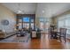 Open-concept living room featuring high ceilings, hardwood floors, and an abundance of natural light at 12957 W 78Th Cir, Arvada, CO 80005