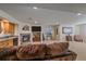 Spacious living room includes a fireplace, bar area, and comfortable seating, perfect for entertaining at 12957 W 78Th Cir, Arvada, CO 80005