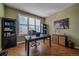 Well-lit home office featuring hardwood floors, modern desk, and a comfortable workspace at 12957 W 78Th Cir, Arvada, CO 80005