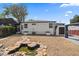 Backyard features a decorative pond and access to a storage shed, offering outdoor charm at 716 S Osage St, Denver, CO 80223