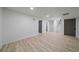 Finished basement features wood-look floors, neutral walls, and multiple doorways, ready for customization at 716 S Osage St, Denver, CO 80223