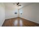 Bright bedroom featuring hardwood floors, a ceiling fan, and two windows allowing for natural light at 716 S Osage St, Denver, CO 80223