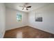 Well-lit bedroom featuring hardwood floors, a ceiling fan, and two windows with outdoor views at 716 S Osage St, Denver, CO 80223