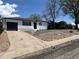 A cozy home with a single-car garage, simple rock landscaping, and a concrete driveway at 716 S Osage St, Denver, CO 80223