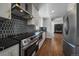Updated kitchen with modern appliances, black backsplash and stylish finishes at 716 S Osage St, Denver, CO 80223