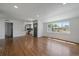 Open-concept living space with hardwood floors and natural light flowing into the modern kitchen at 716 S Osage St, Denver, CO 80223
