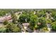 Aerial view of a home nestled among lush trees in a suburban neighborhood at 7742 W Florida Dr, Lakewood, CO 80232