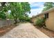 Enjoy this large backyard, featuring a stone patio and mature trees, perfect for outdoor entertaining at 7742 W Florida Dr, Lakewood, CO 80232