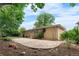 Spacious backyard with large stone patio, mature trees and garden beds offer an outdoor retreat at 7742 W Florida Dr, Lakewood, CO 80232