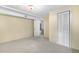 A basement with neutral carpeting, yellow walls, and a view to another room at 7742 W Florida Dr, Lakewood, CO 80232