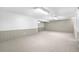 A spacious basement featuring neutral carpeting, paneled walls, and ample lighting ready for your customization at 7742 W Florida Dr, Lakewood, CO 80232