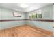 A well-lit bedroom with hardwood flooring and two windows at 7742 W Florida Dr, Lakewood, CO 80232