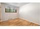 Bright bedroom has hardwood floors and a large window at 7742 W Florida Dr, Lakewood, CO 80232