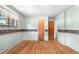 A quaint bedroom with a floral wallpaper border and hardwood flooring at 7742 W Florida Dr, Lakewood, CO 80232