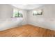 Cozy bedroom features hardwood flooring, floral wallpaper border, and natural light at 7742 W Florida Dr, Lakewood, CO 80232