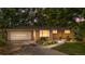 Charming single-story home featuring a well-manicured lawn, and an attached garage with a driveway at 7742 W Florida Dr, Lakewood, CO 80232