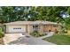 Charming one-story brick home with a well-manicured front yard and an attached two-car garage at 7742 W Florida Dr, Lakewood, CO 80232