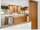 Bright kitchen features stainless appliances, wood cabinets, granite counters, and recessed lighting at 7742 W Florida Dr, Lakewood, CO 80232