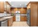 Well-equipped kitchen with stainless steel appliances, wood cabinets, tile flooring, and ample counter space at 7742 W Florida Dr, Lakewood, CO 80232