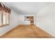 Spacious living room featuring hardwood floors and an opening to the kitchen, creating an open feel at 7742 W Florida Dr, Lakewood, CO 80232