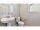 Small bathroom with a modern sink and toilet with natural light from the window at 16840 Mckay Dr, Mead, CO 80542