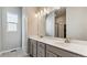 Modern bathroom featuring double sink vanity with sleek countertops and contemporary lighting fixtures at 16840 Mckay Dr, Mead, CO 80542