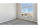 This bedroom features a large window with neighborhood views and neutral colored walls and carpet at 16840 Mckay Dr, Mead, CO 80542