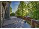 Large backyard deck area surrounded by mature trees, offering privacy and space for entertaining at 2587 S Flanders Ct, Aurora, CO 80013