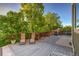 A relaxing backyard deck area features lush greenery and lounge chairs to enjoy the scenery at 2587 S Flanders Ct, Aurora, CO 80013
