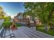 View of the wooden deck and outdoor fireplace in the backyard of this lovely home at 2587 S Flanders Ct, Aurora, CO 80013
