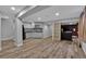 Large finished basement area features modern flooring, kitchenette and access to media room at 2587 S Flanders Ct, Aurora, CO 80013