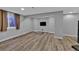 Spacious basement area featuring modern flooring, neutral paint, and a mounted television at 2587 S Flanders Ct, Aurora, CO 80013
