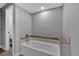 Bathroom featuring a white soaking tub with decorative tile surround at 2587 S Flanders Ct, Aurora, CO 80013