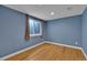 Bedroom with blue walls and wood floor at 2587 S Flanders Ct, Aurora, CO 80013