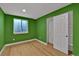 Bright bedroom featuring colorful walls, wood floors, and sliding door closet at 2587 S Flanders Ct, Aurora, CO 80013